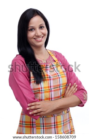 Portrait of young woman with kitchen apron against white background