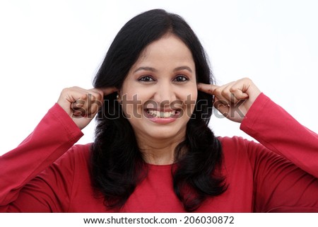 woman with fingers in ears against white