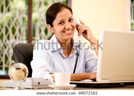 Cheerful business woman talking on phone