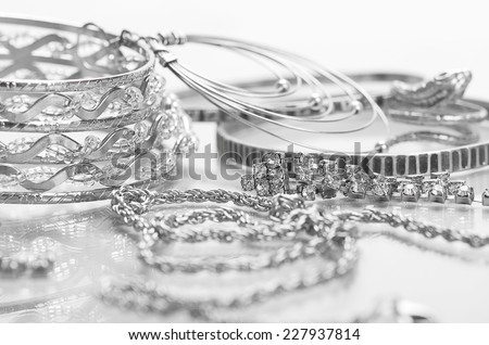 Different silver jewelry on the table.
