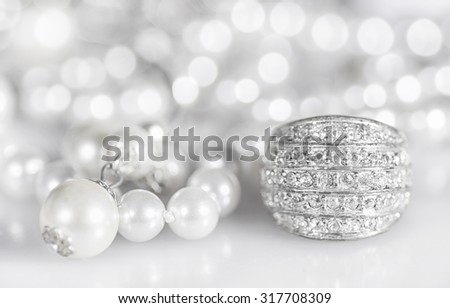 Silver jewelry with pearls and diamonds.