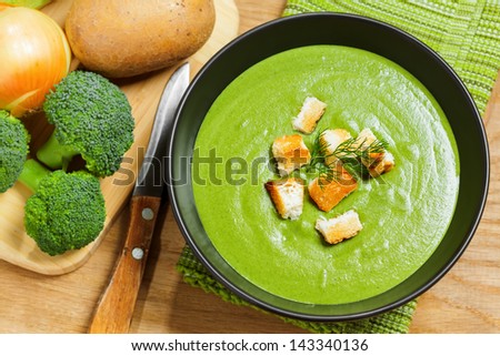 Broccoli cream soup and ingredients on table