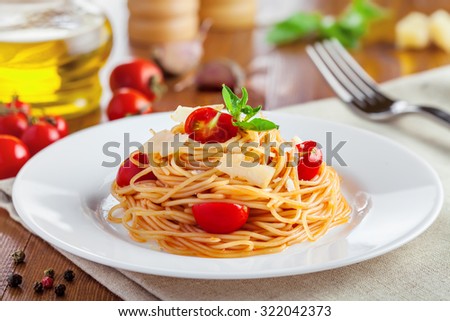 Spaghetti with tomato sauce, parmesan cheese and basil, delicious Italian food