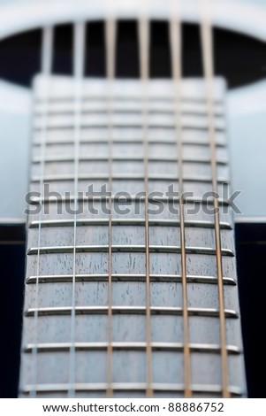 Guitar neck closeup, strings, guitar body on background