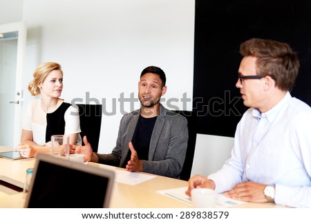 Group of young executives having a meeting in office conference room.