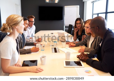 Group of young executives holding a work meeting in a conference room