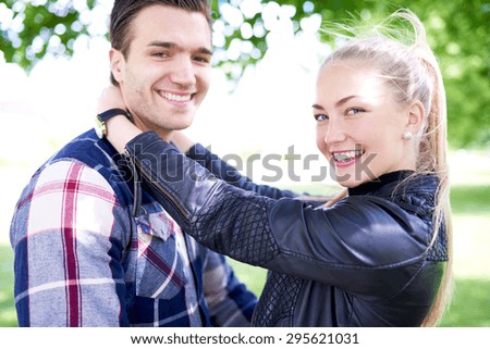 Close up Sweet Young White Couple at the Park, Holding Each Other and Smiling at the Camera