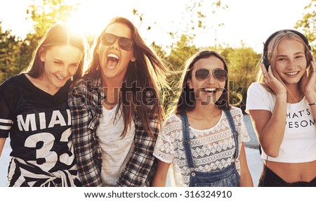 Group of teenagers laughing out loud on s summer day