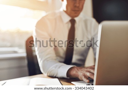 Business close up, executive working on laptop while sitting at office