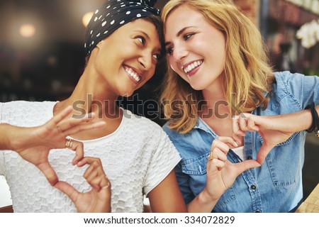 Black and white women, best friends, on a cafe