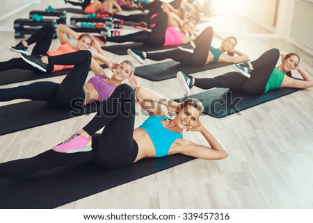 Group of fit healthy young women in a gym wearing colorful sportswear working out in an aerobics class in a healthy active lifestyle concept