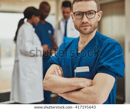 Serious surgeon in front of team of doctors having a meeting at hospital