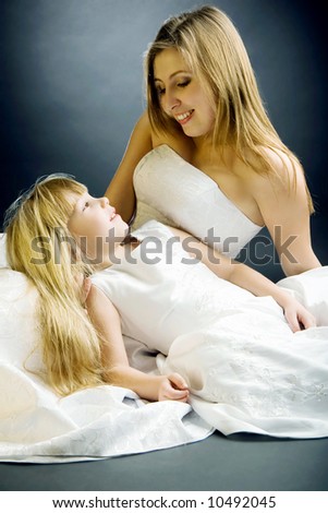 Mother with daughter in wedding dresses