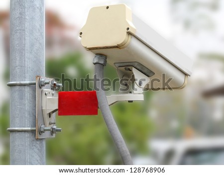 Closeup image of CCTV security camera outdoor at car park