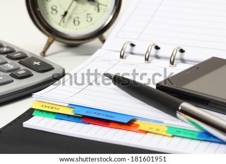 closeup image of pen and mobile phone on business book for working
