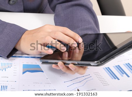 closeup image of business woman touch tablet for working on white desk