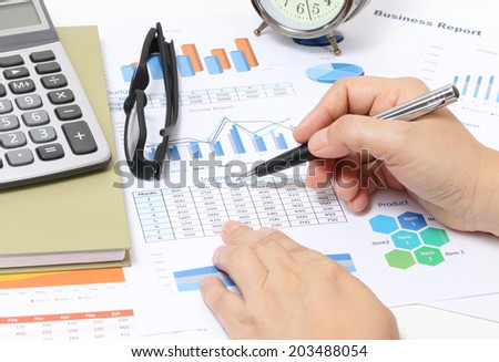closeup image of business woman working financial report at her office