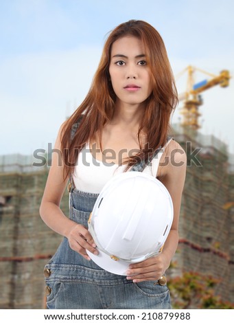 woman worker holding white helmet on hand for a job at workplace