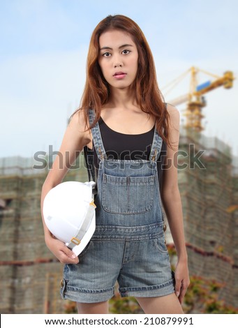 woman worker holding white helmet on hand for a job at workplace