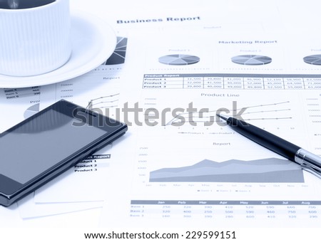 image of business graph  with black coffee and financial report on table
