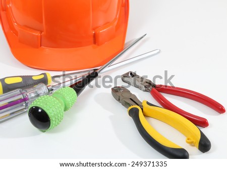 Image of helmet pliers tools and business report for construction on white desk