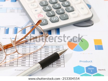 image of pen calculator and glasses on financial report