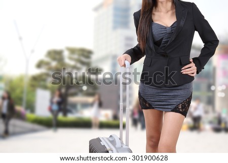 traveler woman in black suite holding suitcase for travel