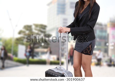 traveler woman in black suite holding suitcase for travel