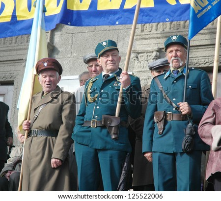 TERNOPIL , UKRAINE - OCTOBER 17: Unidentified veterans hold various flags during military parade Ukrainian Liberation Army, October 17, 2005 in Ternopol, Ukraine