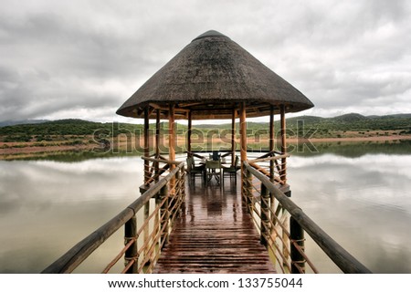 Wedding chapel and restaurant on lake in mountains. Shot in a game lodge near Oudtshoorn, Karoo, Western Cape, South Africa.