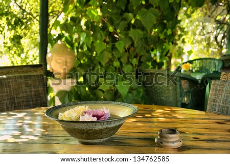 Plate with flowers in outdoor Thai restaurant. Shot in Western Cape, South Africa.