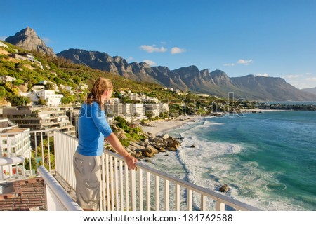 Young Man On Terrace Looks At Beach Panorama. Shot In Cape Town, South Africa.