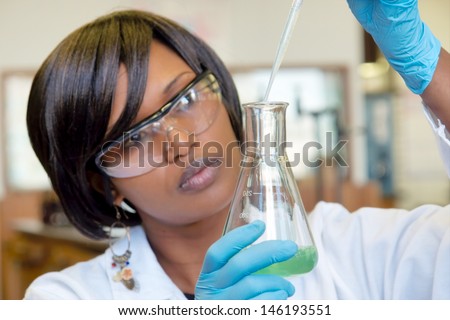 African Female Researcher With Glass Equipment In The Lab - Soft Focus On Glass And Hands.