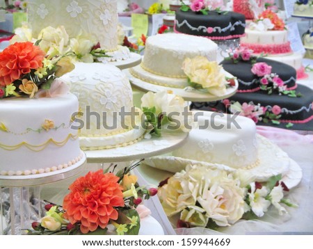Many big cream cakes on table.