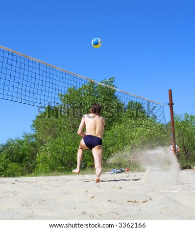 Playing beach volleyball - man runs after ball. Shot in Ukraine.
