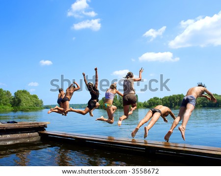 'Seven samurai group of kids jumps into water from pier Shot in June Dnieper river Ukraine. 'Seven samurai group of kids jumps into water from pier Shot in June Dnieper river Ukraine.