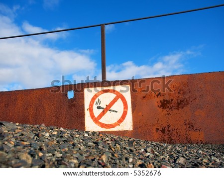 Rusty no fire and smoking sign board in an open-cast mine. Shot in Poltavska Region, Ukraine