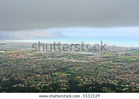 View at False Bay from misty mountains in cloudy day. Shot in the Helderberg Mountains nature reserve, Western Cape, South Africa.