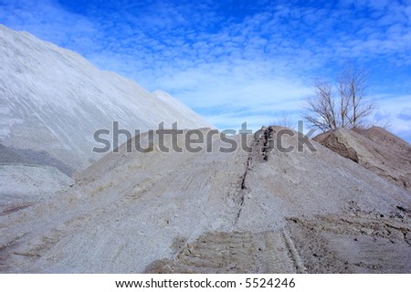 Mine artificial hill, road and skies. Shot in March, in a stone open-cast mine, Poltavska Region, Ukraine