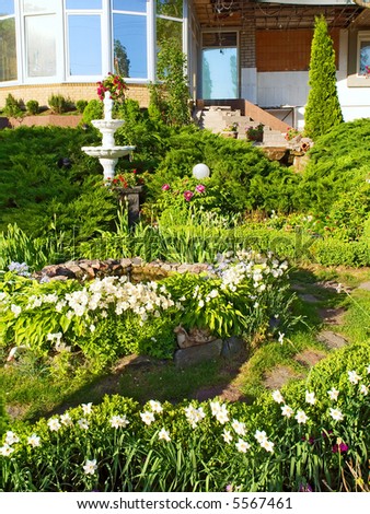 Garden with fountain and white flowers in front of office. Shot in Kremenchug, Ukraine.