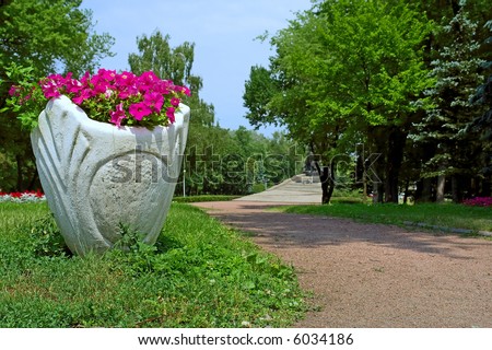 Dirty vase with flowers in park - low angle view. Shot in Kiev (Kyiv), Ukraine.