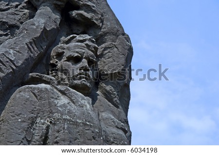 Face of strong man in black stone. Shot in Ukraine.