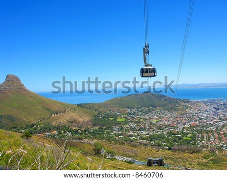 Bird-eye view at cable car cabin and Cape Town and Lion\'s peak from Table Mountain. Shot in Table Mountain (cable car area), Cape Town, South Africa.