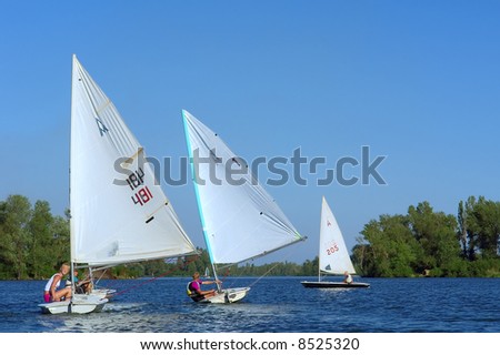 Four yachts on river about to start. Shot in July, Dnieper river, Ukraine.