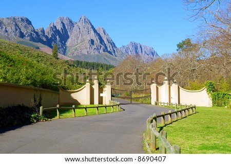 Entrance into wine estate in front of awesome mountains. Shot in August, near Stellenbosch, South Africa.