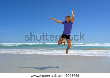 Young happy man jumps on sea beach. Shot in Hermanus, Walker Bay, Western Cape, South Africa.