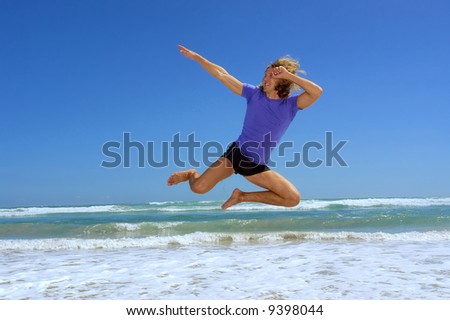 Young man jumps on sea beach with funny posing. Shot in Hermanus, Walker Bay, Western Cape, South Africa.