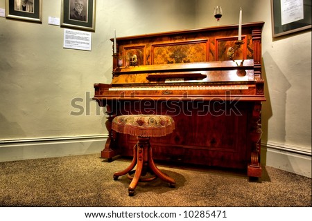 Antique piano in museum - dramatic light. Shot in Stellenbosch, Western Cape, South Africa.