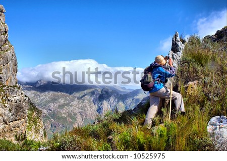 Hiker steps up - and awesome mountain landscape as a background. Shot on Pieke, Jonkershoek Nature Reserve, near Stellenbosch, Western Cape, South Africa.