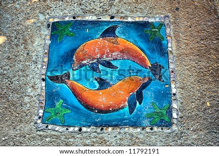 Stone ornament with dolphins. Shot in Sodwana Bay, KwaZulu-Natal, South Africa and Southern Mozambique.